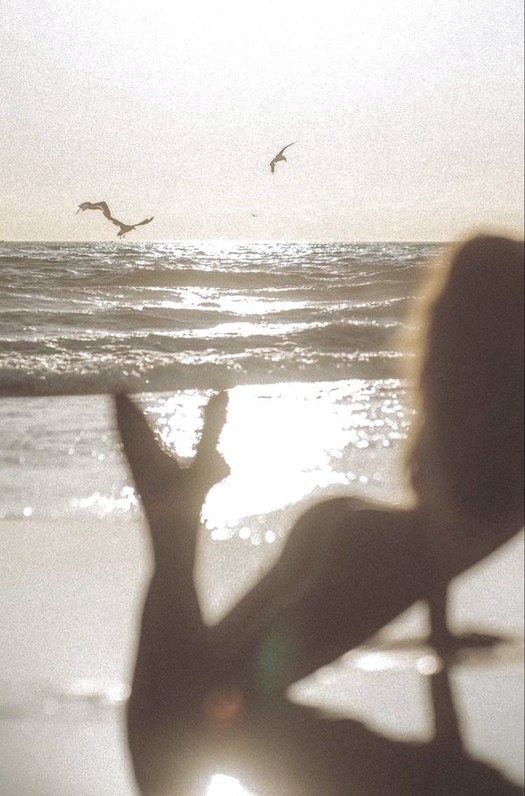 Silhouette against sun-glared ocean light