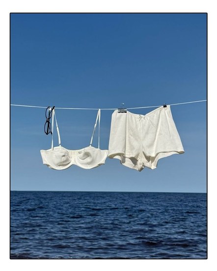 White linens on a clothesline over the sea